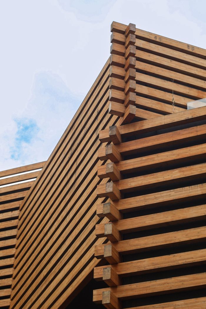 Close-up of wooden beams in modern architectural design, highlighting craftsmanship and style.