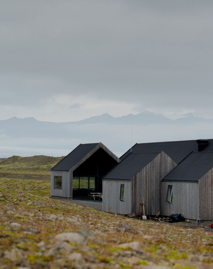 Contemporary house in Iceland's rugged landscape, showcasing modern architecture.