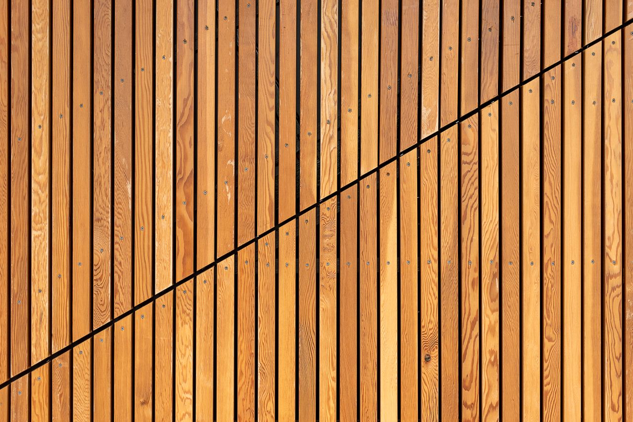 A close-up of wooden slats creating a modern diagonal pattern, ideal for backgrounds.